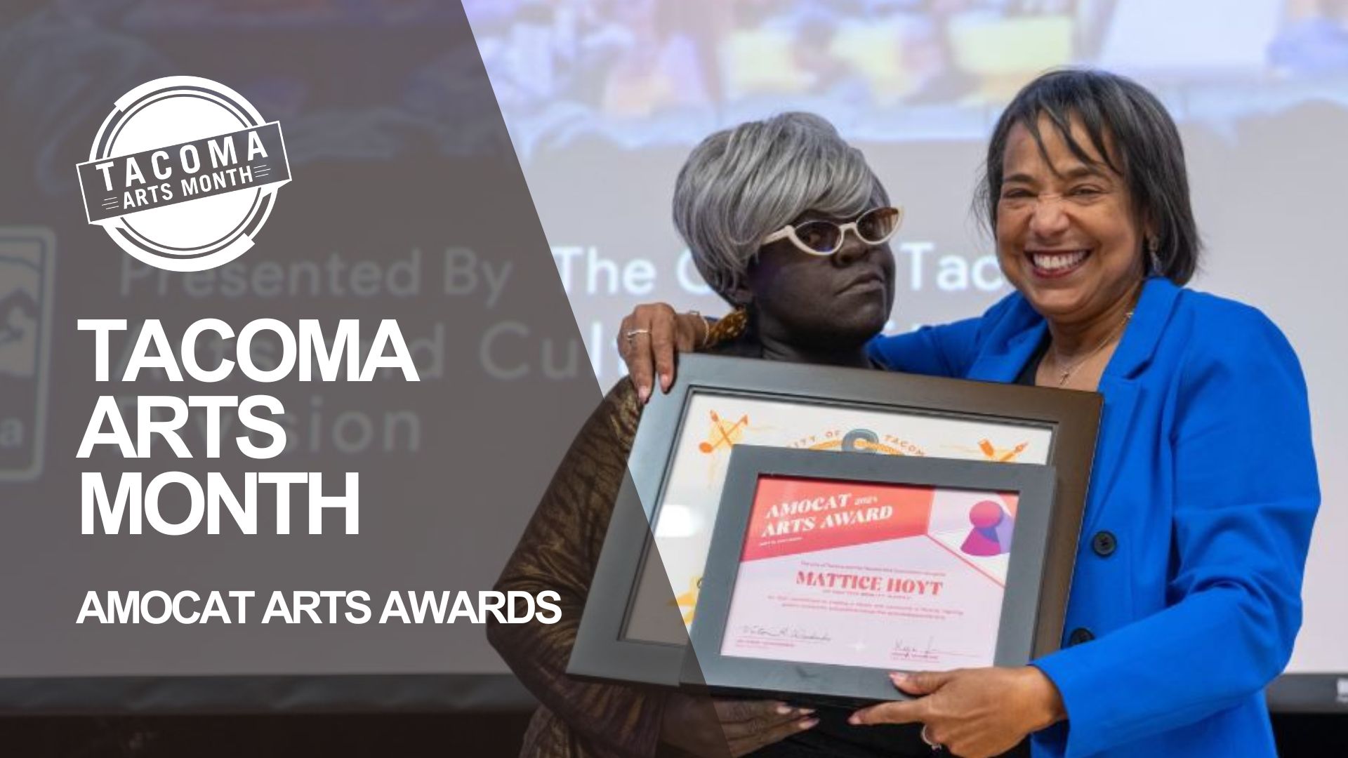 Former City of Tacoma Mayor Victoria Woodards presents an award to the late and beloved Mattice Hoyt in a gold-patterned dress, who is wearing glasses during the AMOCAT Arts Awards during Tacoma Arts Month