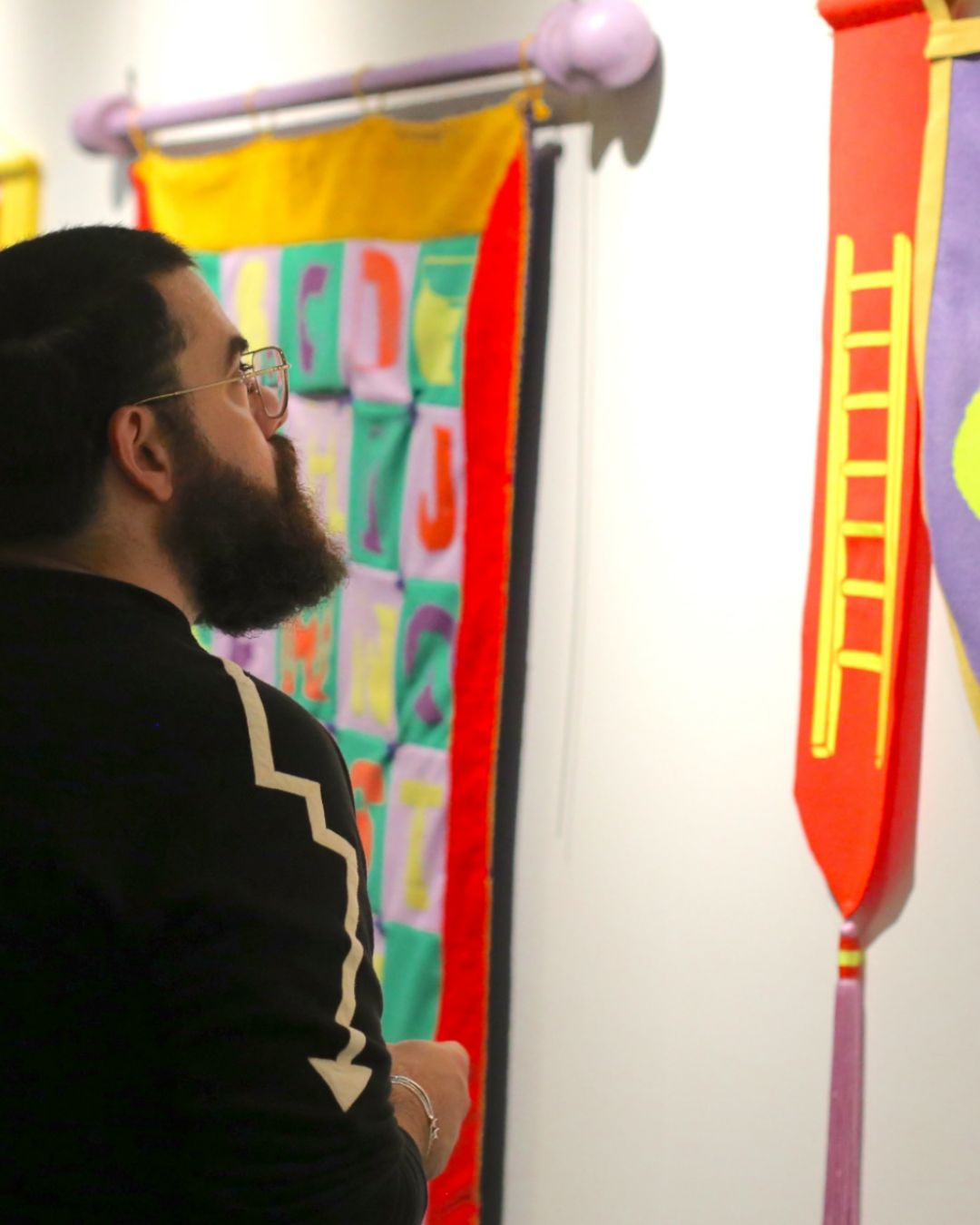 A participant enjoys artworks from Gillian Nordlund at Kaleidoscope, the opening celebration of Tacoma Arts Month. 